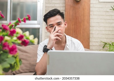 A Young Man Stuck In Rut Looking At The Camera. Unable To Solve A Problem On A Computer Project. Mental Block Or Fatigue Concept.