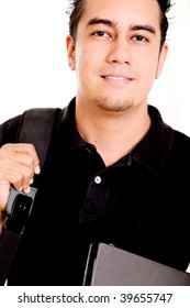 Young man. Student looking at the camera smiling with books and  briefcase
