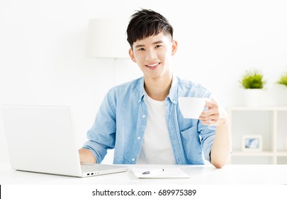 Â relaxed Young Man Studying And Drinking Coffee