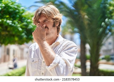 Young Man Suffering For Bad Smell At Park