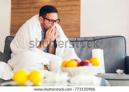 Young man suffering from cold at his home