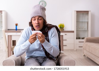 Young Man Suffering From Flu At Home