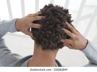 Young Man Suffering From Itchy Scalp