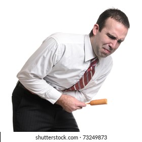 A Young Man Suffering From A Stomach Ache Due To Eating A Bad Corn Dog. Isolated Against A White Background.