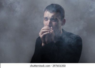 Young Man Suffocating In The Poisonous Smoke