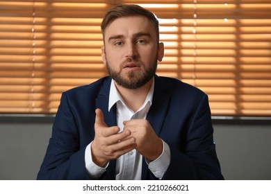 Young Man In Suit Holding Online Webinar Indoors, View From Webcam