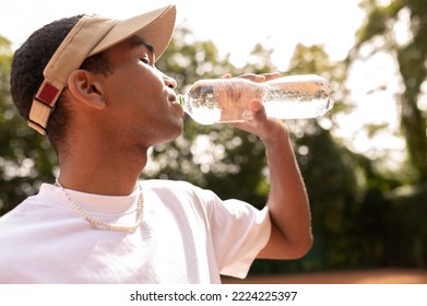 Young man in sun visor with a bottle of water in hands - Powered by Shutterstock