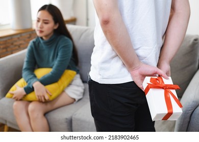 Young man surprise girlfriends with a gift box held on the occasion of the anniversary of love. - Shutterstock ID 2183902465