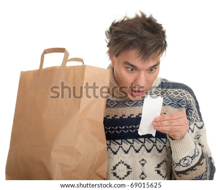 young man surprised expression looking at store receipt