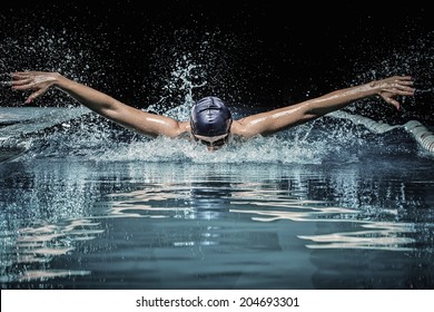 Young Man In Swimming Cap And Goggles Swim Using Breaststroke Technique 