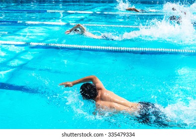 Young Man Swimming Freestyle In A Race.