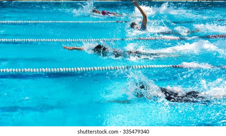 Young Man Swimming Freestyle In A Race.