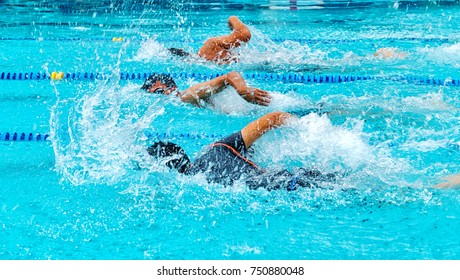 Young Man Swimming Freestyle In A Race.