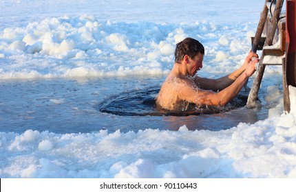 Young Man Swimming In An Ice Hole