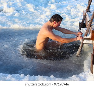 Young Man Swimming In An Ice Hole