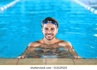 Young man in swimming pool - Powered by Shutterstock