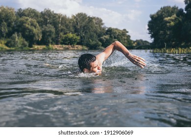 The young man swimming in the river. - Powered by Shutterstock