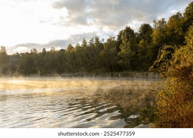 The young man swimming in the river. Misty sunrise over a lake. A foggy morning on autumn by a small lake. Misty reflection in water. Dreamy wanderlust - Powered by Shutterstock