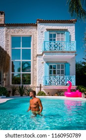 Young Man At An Swimmingpool With Red Pink Flamingo,pink Flaming By The Pool Alacati Colorful House Turkey