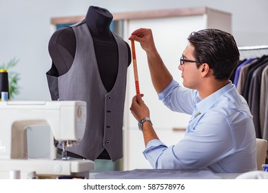 Young man tailor working on new clothing