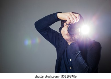 Young Man Takes A Picture On A Camera With Built-in Flash. Bright Light For Illumination Of The Frame.