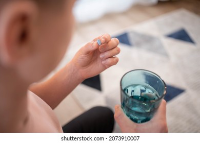 A young man takes a prep in a pill. HIV prevention concept. AIDS prevention concept. HIV AIDS
