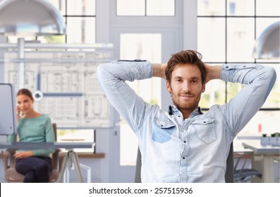 Young man taking break of work at trendy architect office - Shutterstock ID 257515936
