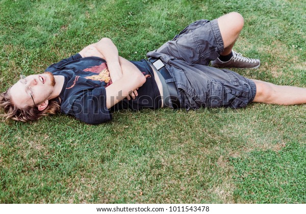 Young man\
taking a nap on meadow - Kempen,\
Germany