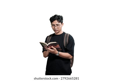 Young Man Taking Notes in Notebook While Wearing Backpack