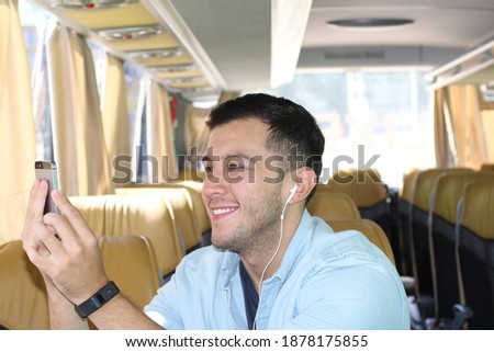 Young man taking pictures from bus window