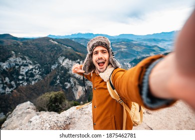 Young Man Taking A Selfie With Mobile Smart Phone Hiking Mountains - Happy Smiling Guy Looking At Camera - Warm Autumn Filter