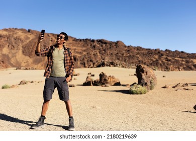 Young Man Taking Selfie Photo On A Road Trip. Man Making Memories On The Mountain