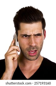 Young Man Is Talking Angry On The Phone - Young Adult Is Angry While Talking On The Telephone.