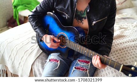 Similar – Young Boy Enjoying Music Playing Guitar Outdoors