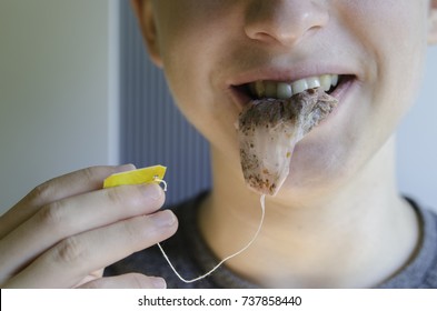 Young Man With Tea Bag In His Lips