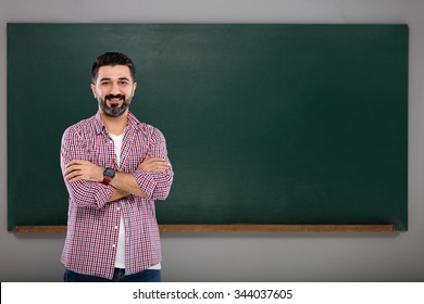 Young Man Teacher On Green Board.