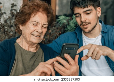 young man teaching grandfather mobile phone - Powered by Shutterstock