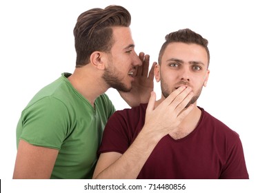 Young man telling secrets to his friend, isolated on white background