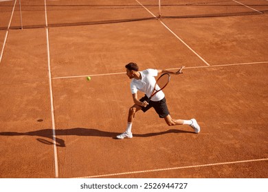 Young man, tennis player showing endurance and strength during intensive training on clay court. Man practicing for upcoming game. Concept of sport, competition, active and healthy lifestyle - Powered by Shutterstock