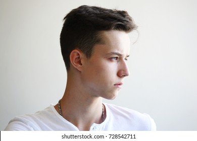 Young Man Tense Face On A Grey Background