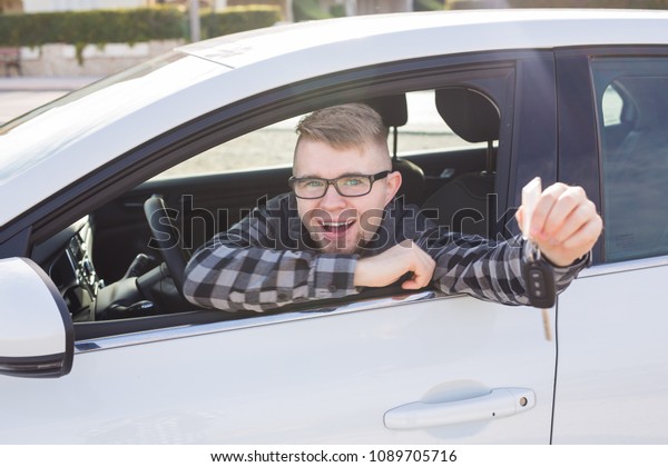 Young man test drive new\
car.