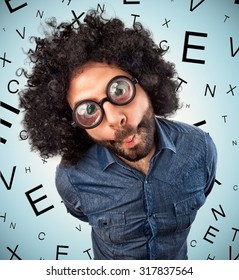 Young Man With Thick Glasses On Background With Letters For Checking Eyesight