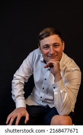 Young Man In Thinker Pose Smiling