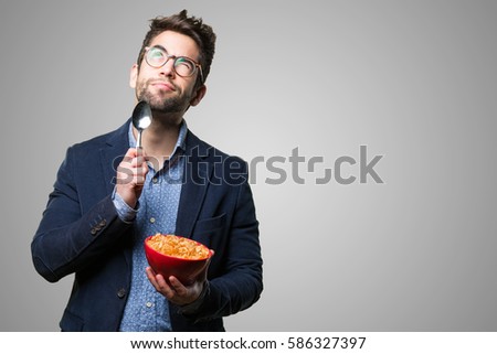 young man thinking holding corn flakes stock photo edit now
