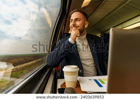 Young man thinking over he's project ideas as he looks out the window on his commute to work