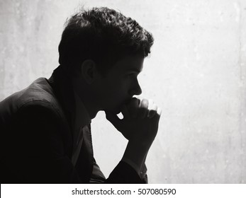Young man in thought, side view, horizontal image