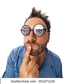 Young Man With A Thoughtful Expression And Thick Glasses On White Background.