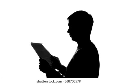 Young Man Thoughtfully Reading A Book - Silhouette