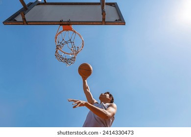 Young man throwing the basketball - Powered by Shutterstock