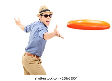 Young man throwing a frisbee disk isolated on white background